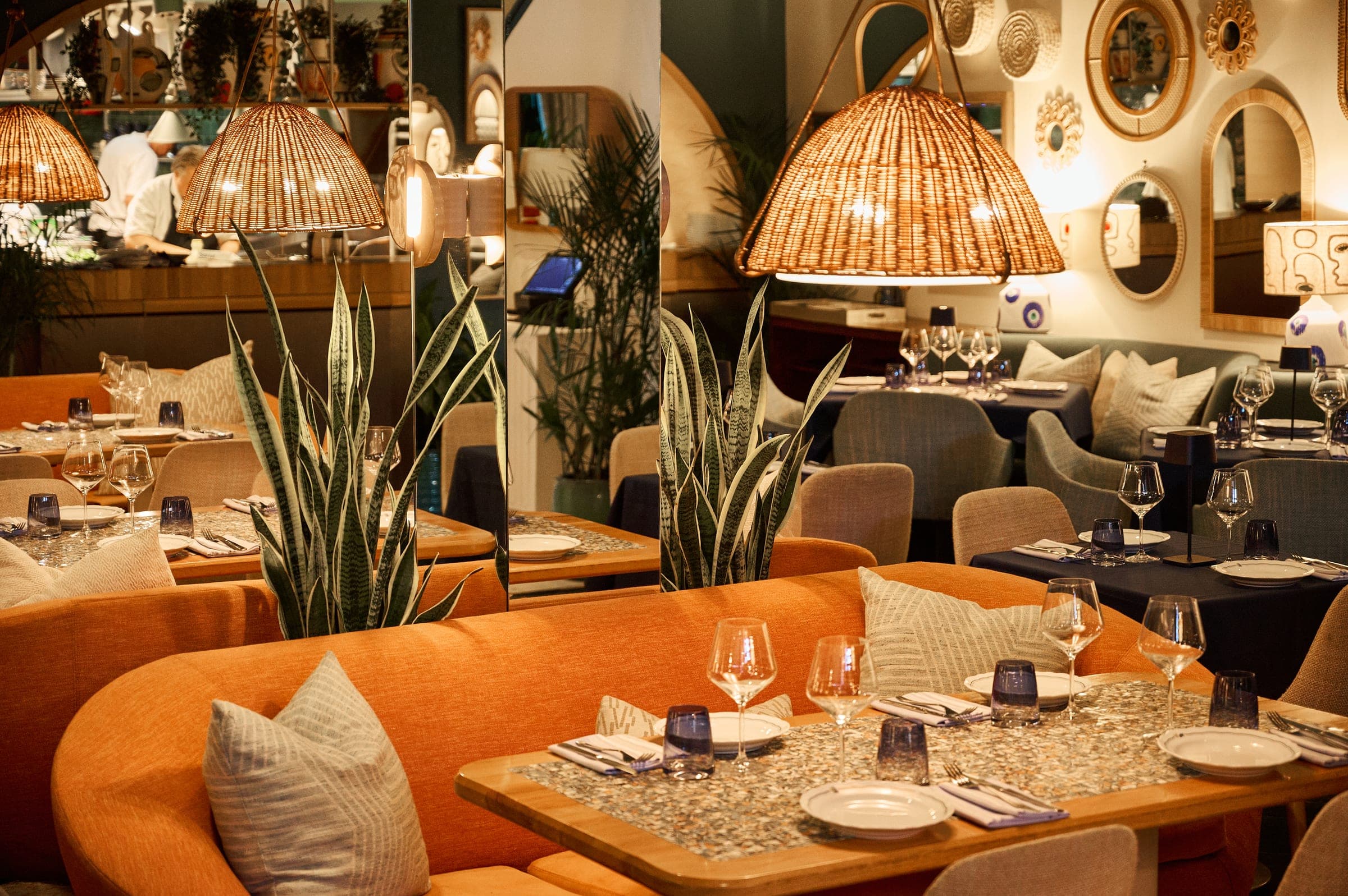 Dining room tables beneath woven rattan pendant lighting
