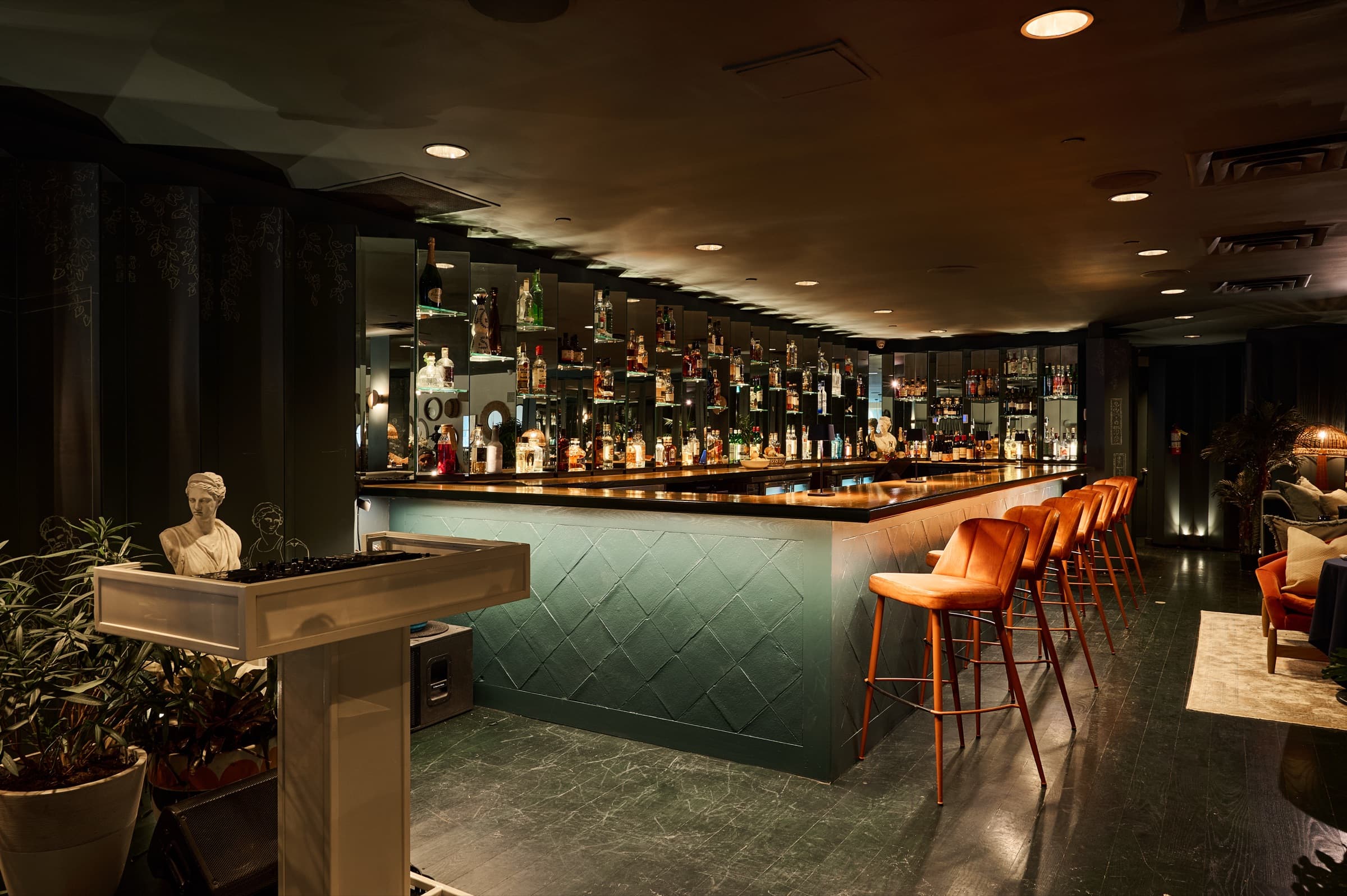 Mezzanine bar at Meláni with backlit bottle display and lounge seating